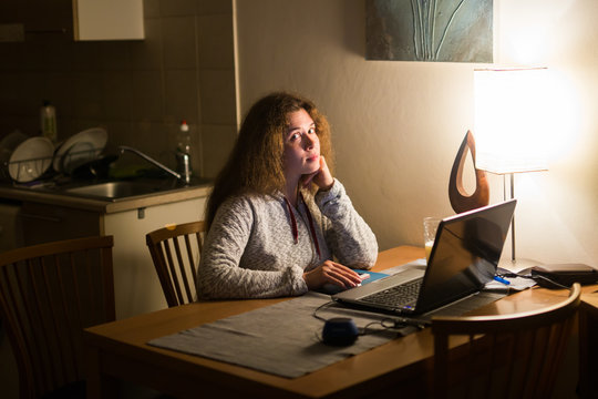Woman working with laptop computer at night