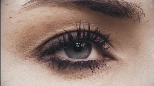 Beautiful green eye of woman opens- macro