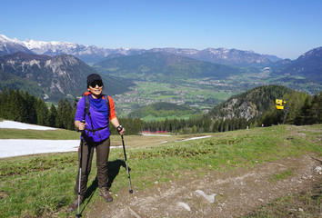 Female trekker standing on with mountain landscape background