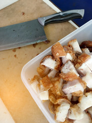 Fototapeta na wymiar crispy pork with knife on cutting board.