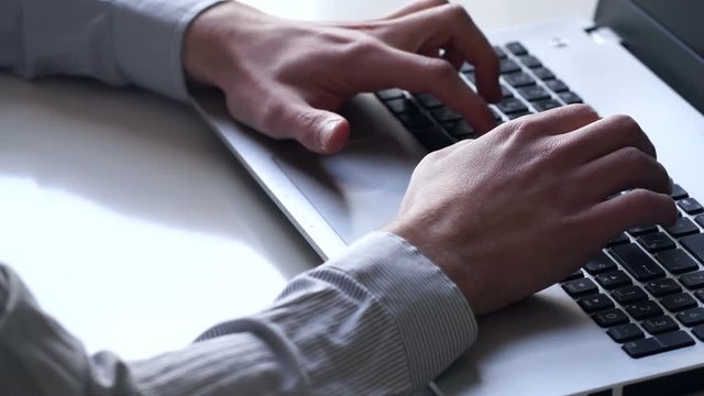 Close-up of hands and keyboard. Clerk working on laptop. Business and office concept.