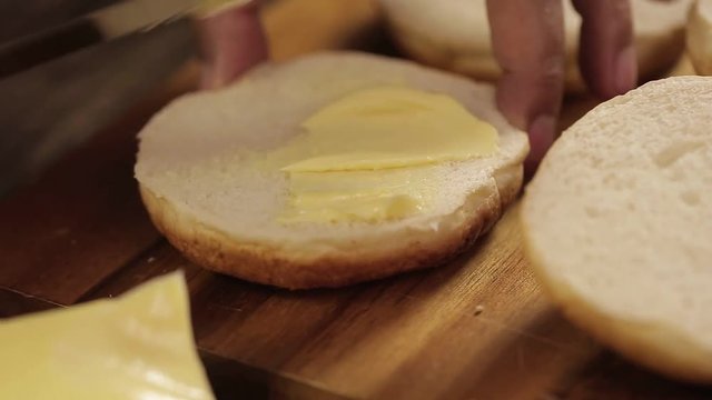 Buns - Putting Butter On Round Cut Buns - Side Angle