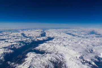 Fototapeta na wymiar View over the alps from high altitude in spring