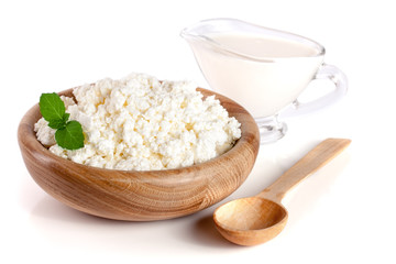 Cottage cheese in a wooden bowl isolated on a white background