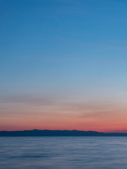 Naklejka na ściany i meble Scenic sunset over blue sea long exposure