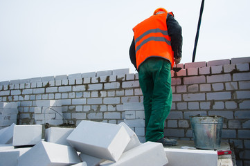 Construction mason making a brickwork
