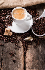 Coffee on a wooden table. Dark background.