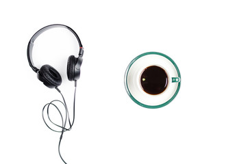 Headphones with mug of coffee on a white background.