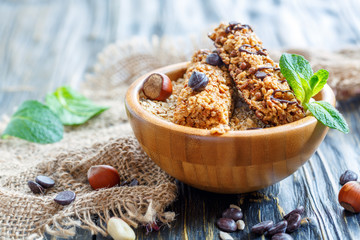 Bowl of cereal bars with chocolate and nuts.
