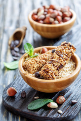 Honey bars with chocolate and hazelnuts in bowls.