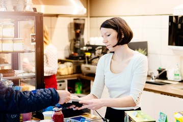 Customer paying with credit card in small shop