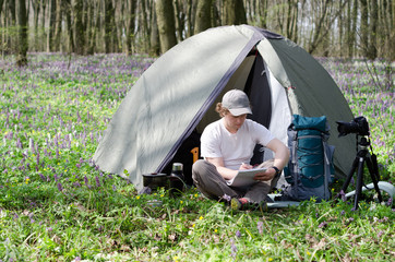 Tourist takes notes in a notebook.