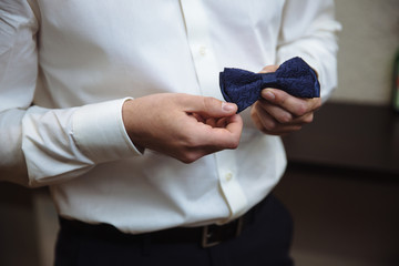 Man holding bow tie. Elegant gentleman clother.
