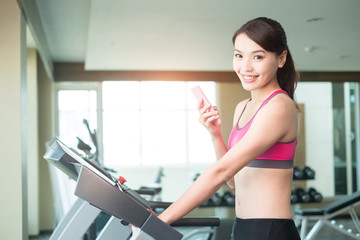 Fototapeta premium woman stand on treadmill