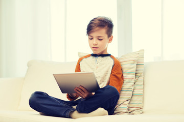 boy with tablet computer at home