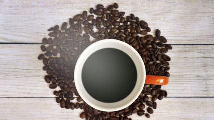 Coffee cup and coffee bean on wooden table
