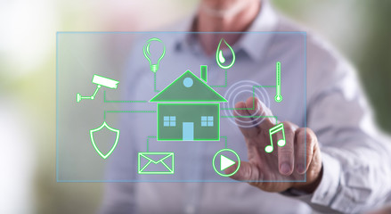 Man touching a digital smart home automation concept on a touch screen