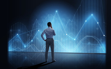 businessman looking at virtual diagram chart