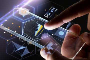 hands with smartphone and virtual charts