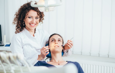 Portrait of a female dentist and her patient.