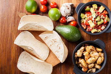 Ingredients ready for preparing chicken tacos with salsa made fr