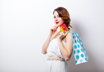 portrait of beautiful young woman with dotted shopping bag on the wonderful studio background