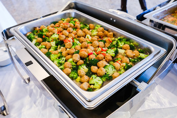 Stir-fried broccoli with shrimp balls on silver tray