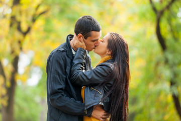 Fototapeta premium photo of cute couple kissing on the wonderful autumn park background