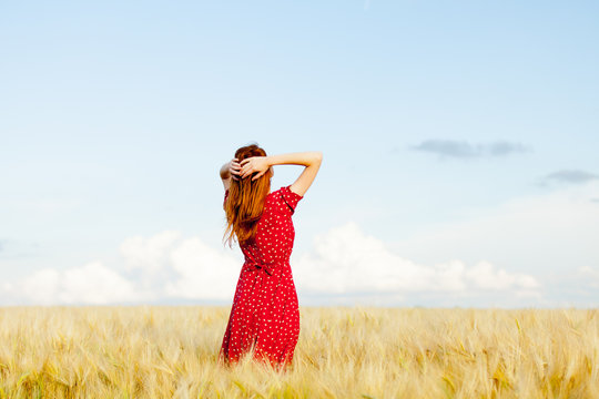 photo of beautiful young woman on the wonderful wheat field background