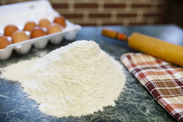 different ingredients for preparing flour products on kitchen table