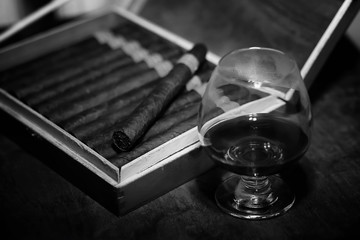Retro styled photo of large box of Cuban cigars on a wooden table