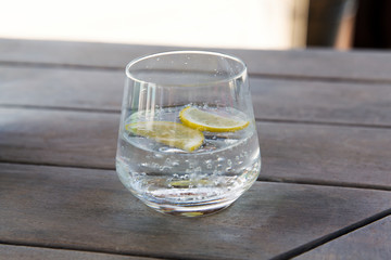 glass with cold water or cocktail on bar table