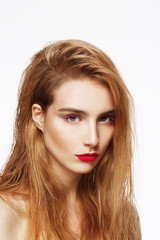 Fototapeta premium Close-up portrait of young beautiful confident sad girl with bright make up. White background. Isolated.