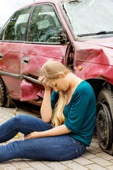Upset driver woman in front of automobile crash car.