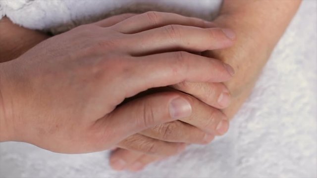 A man caresses a wrinkled woman's hand,full hd video