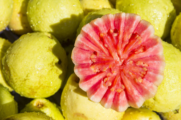 Fresh juicy guava fruit cut open on display at an outdoor farmers market in Rio de Janeiro, Brazil