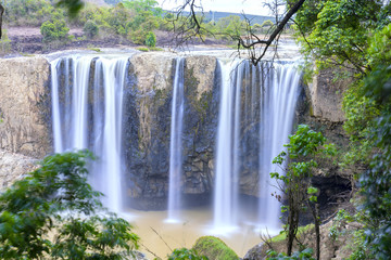 Natural waterfalls in the wild forest with high water flow down to the deep pool to create beautiful soft silk