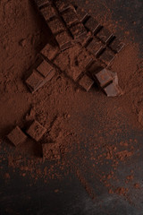 Top view of dark chocolate blocks crashed into pieces