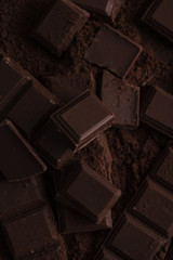 Dark chocolate tile pieces covered in chocolate powder