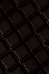 Close up of dark chocolate bar tiles