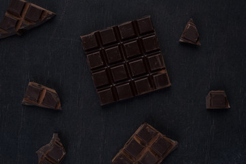 Top view of a dark chocolate bar with pieces