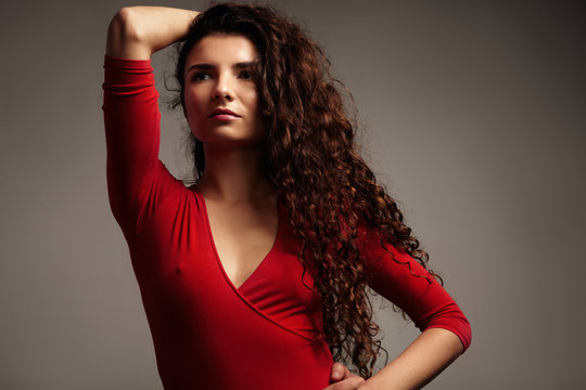 beauty woman with curly hair in red top