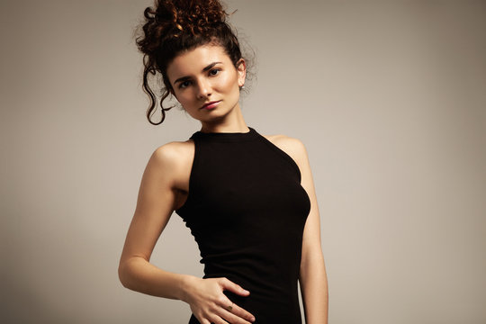 beauty model with curly hair in black dress