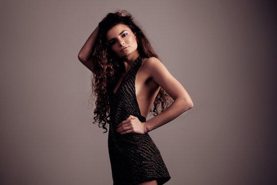 beauty woman with long curly hair in studio shoot
