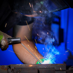 Worker welding the iron