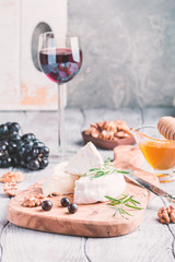 Brie cheese and slice on a wooden board