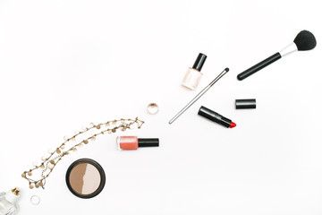 Makeup brushes, nail polish, accessories and lipstick on white background. Copy space, flat lay, top view. Beauty blog theme