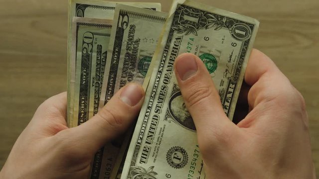 Business man counting cash payment dollars banknotes. Top view. Close up.