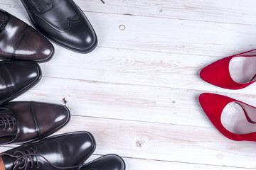 men's and red high heel womens shoes on white background