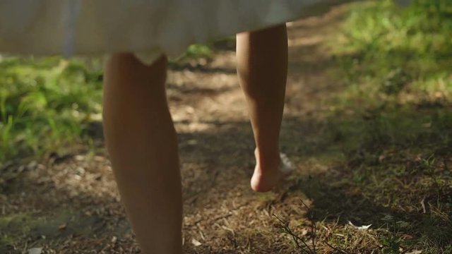 Young Woman Walking In Forest Barefoot